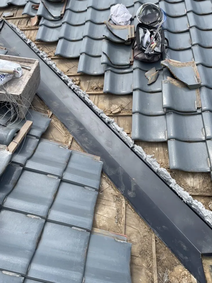 新しい谷板金と外していた瓦を取り付けていきます。