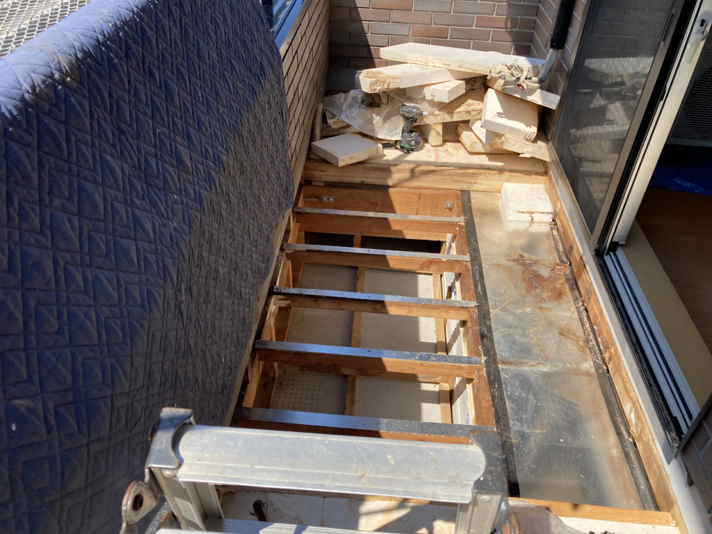 長年にわたって雨水が防水シートの繋ぎ目から染み込み、下地のべニヤ板を腐らせてしまっている状態です。